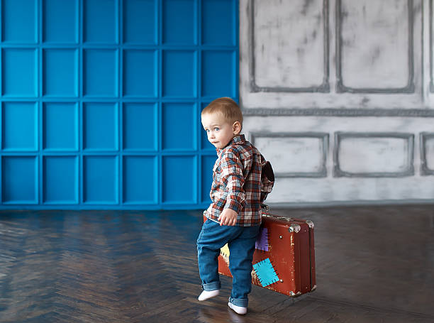 istock The boy with a suitcase in the big room. 515592550