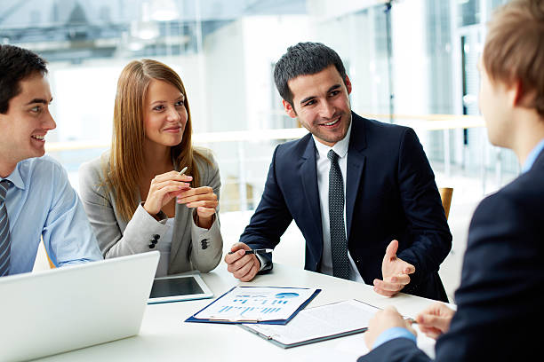 Meeting Image of business partners discussing documents and ideas at meeting business finance and industry stock pictures, royalty-free photos & images