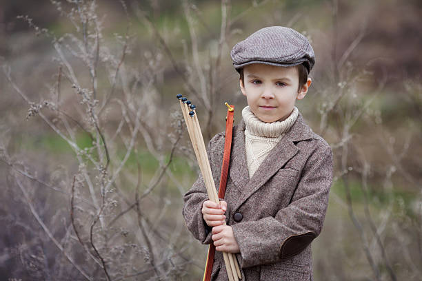 istock Adorable little preschool boy, shoot with bow and arrow 515594988