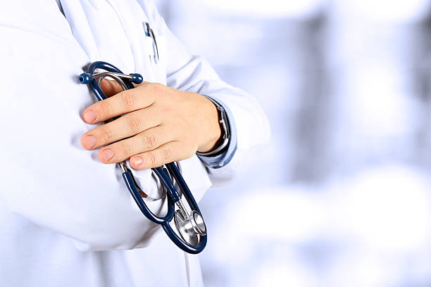 istock Portrait an unknown male doctor holding a stethoscope 515595218