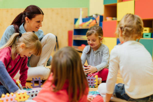 istock Preschool teacher and children in classroom 515595276