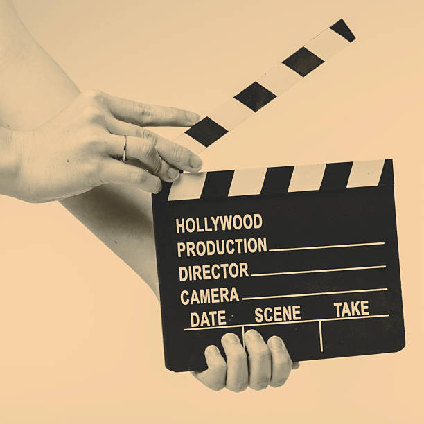 istock Movie flapper in woman hands on white background 515595476