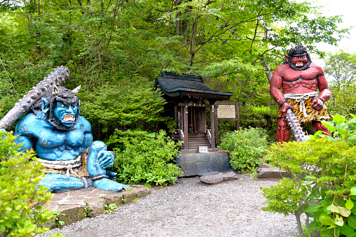 Noboribetsu, Hokkaido, Japan - August 9, 2014: Red and blue demon statues are guarding at the Demon Shrine.  Demon Shrine is one of the popular landmark in Noboribetsu, Hokkaido, Japan