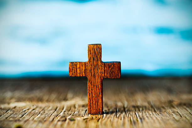 istock christian cross on a wooden surface 515597218
