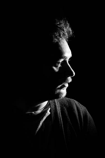 istock Young man's portrait. Close-up face against black background 515597894