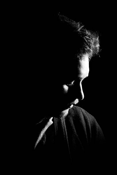 istock Young man's portrait. Close-up face against black background 515598194