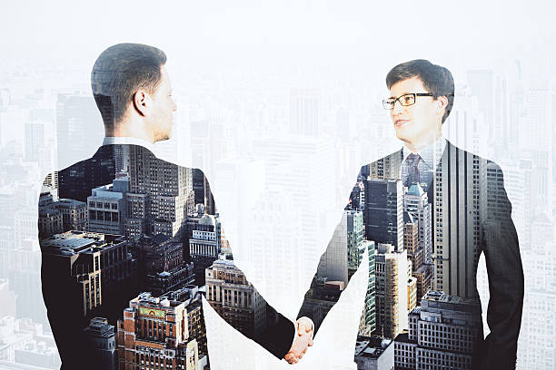 istock Double explosure with businessmen shake hands and financial city 515598244