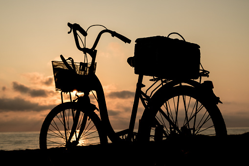 Bicycle on the beach. The morning before the sun rises.