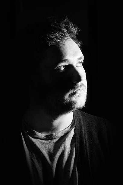 istock Young man's portrait. Close-up face against black background 515599314