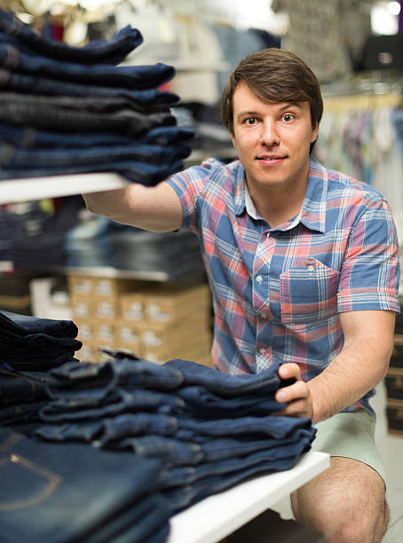 istock Man choosing blue jeans at the shop 515600250