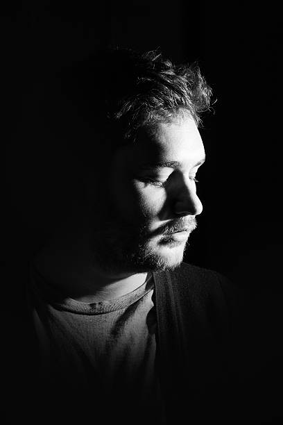istock Young man's portrait. Close-up face against black background 515601008