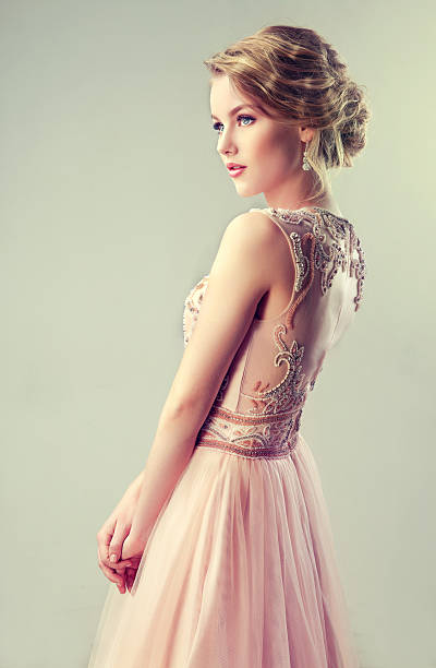 Beautiful girl light brown hair with an elegant hairstyle. Young beautiful woman, dressed in evening gown.Example of wedding hairstyle. blond hair fine art portrait portrait women stock pictures, royalty-free photos & images