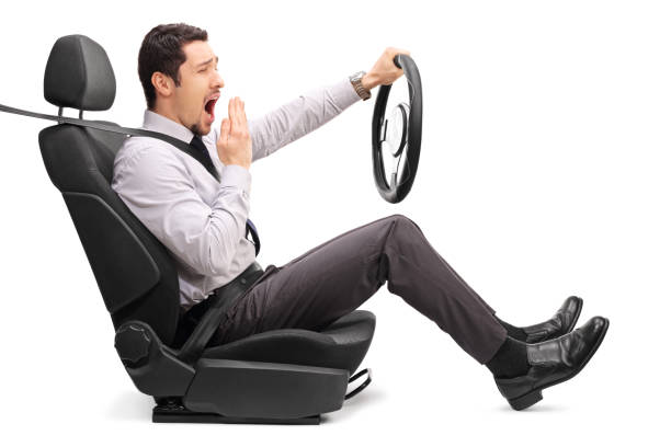 istock Sleepy young guy holding a steering wheel 515601622