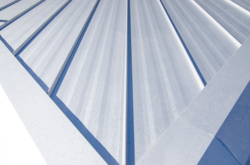 Single-loc Standing Seam Metal Roof with hips running to the ridge.