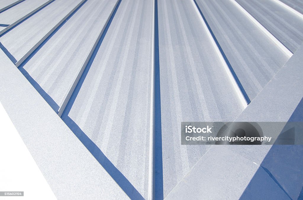 Metal Roof Single-loc Standing Seam Metal Roof with hips running to the ridge. Rooftop Stock Photo