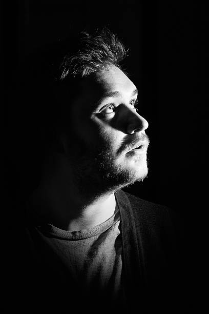 istock Young man's portrait. Close-up face against black background 515603358