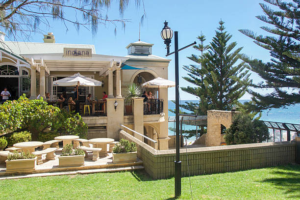 Cottesloe Beach: Indiana Tea House and Indian Ocean Cottesloe,WA,Australia-March 12,2016: Exterior of Indiana Tea House eatery with people at Cottesloe Beach with Indian Ocean views in Cottesloe, Western Australia. cottesloe beach stock pictures, royalty-free photos & images
