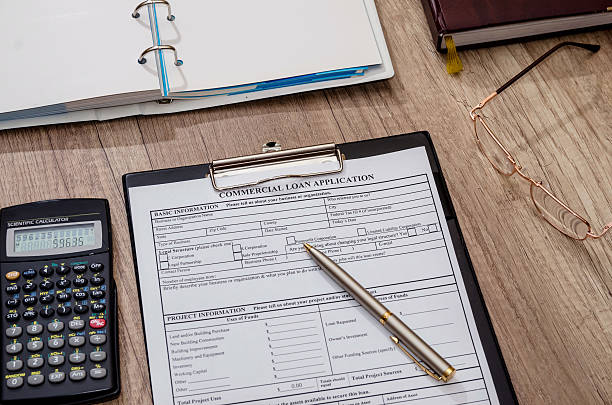 istock File the commercial loan application with calculator, pen on desk 515604584