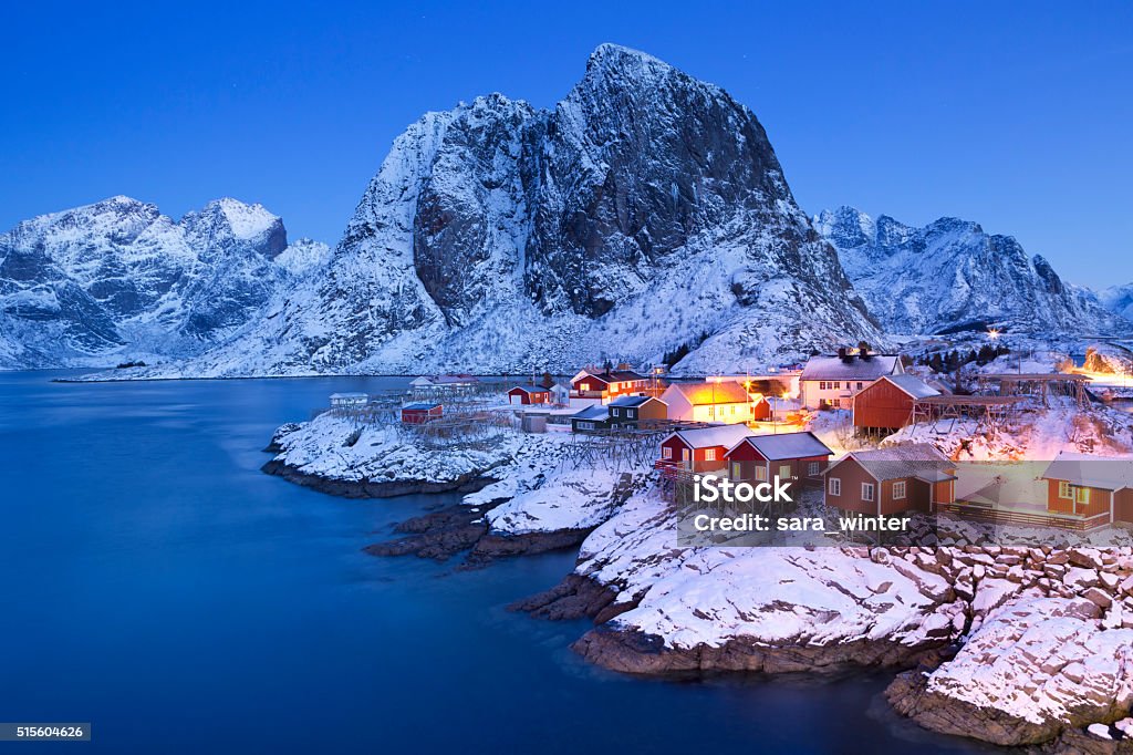 Norwegian fisherman's cabins on the Lofoten at dawn in winter Traditional Norwegian fisherman's cabins, rorbuer, on the island of Hamnøy, Reine on the Lofoten in northern Norway. Photographed at dawn in winter. Norway Stock Photo