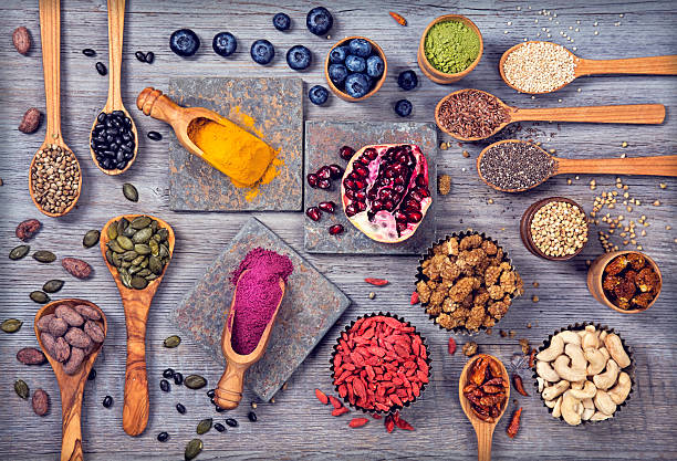 Super foods in spoons and bowls Super foods in spoons and bowls on a wooden background antioxidant stock pictures, royalty-free photos & images