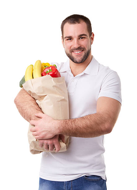 istock Man with paper bag full of vegetables 515607136