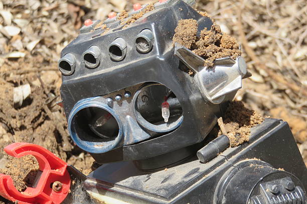 istock Old robot coming out of the ground 515607486