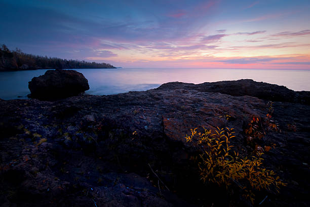 Coastal Sunset with Pebbles in the water on the beach of the Baltic Sea, Darß Peninsula, Germany