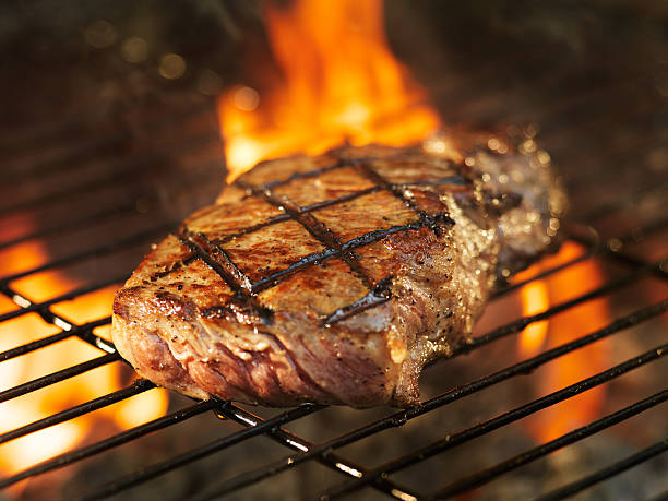 istock beef steak cooking over flaming grill 515628671