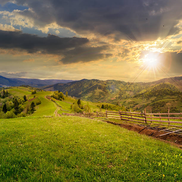 istock fence on hillside meadow in mountain at sunset 515629679
