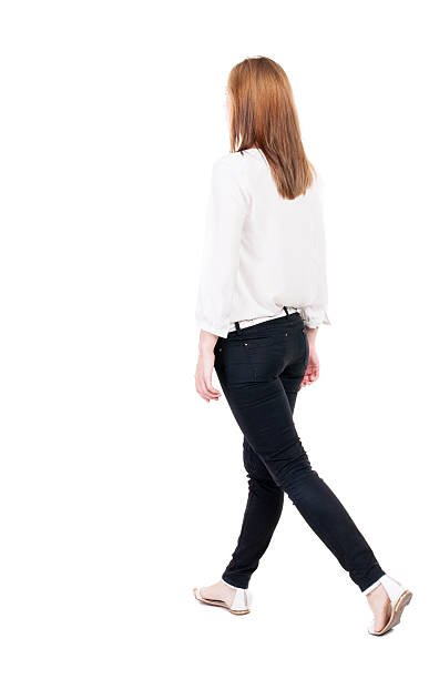 istock back view of walking  woman in jeans. 515629839