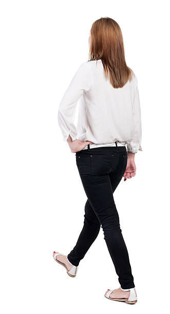istock back view of walking  woman in jeans. 515629843