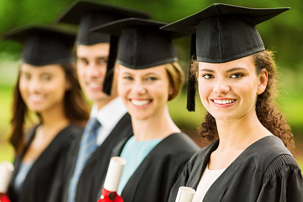 istock Students Wearing Gown And Mortar Board Standing On Campus 515629937