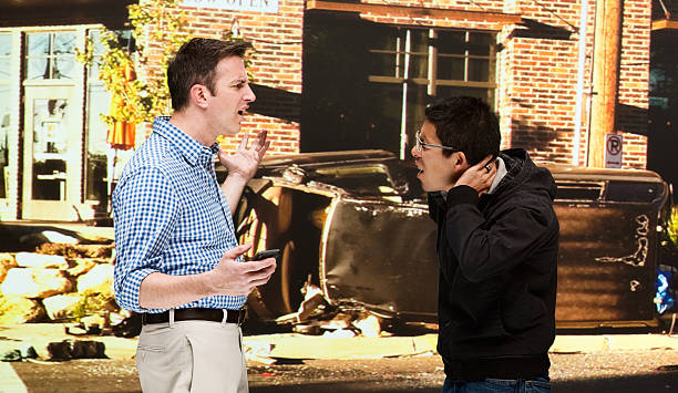 istock Two men quarreling in front of auto accidents 515631553