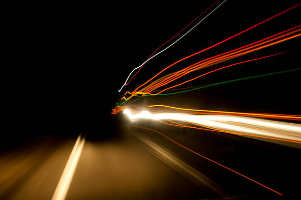 istock Night time highway blurred stream of light as trucks pass 515633421