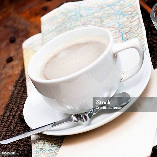 Angled Closeup Of A Cup Of Coffee Sitting On A Roadmap Stock Photo - Download Image Now