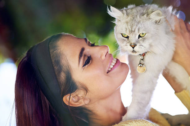 Shot of a gorgeous young woman holding a cat