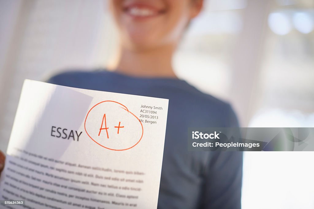 Easy A! Shot of a proud young boy holding up his essay that got him an A+ Paper Stock Photo