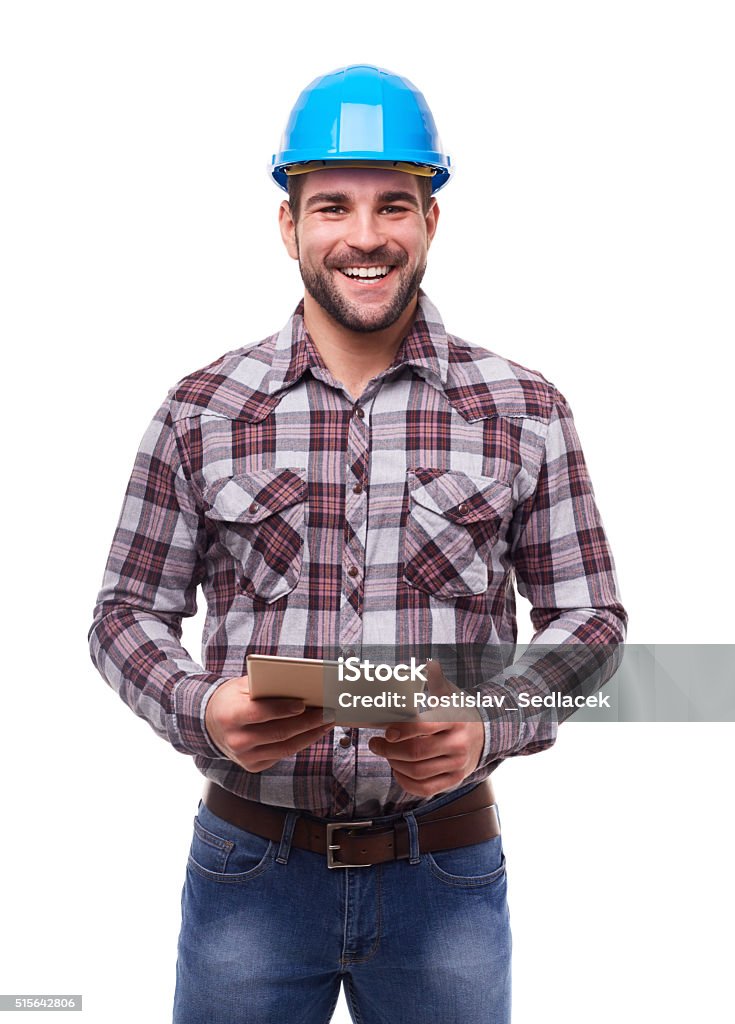 Glückliche Arbeiter in Helm mit einem blauen Digitaltablett - Lizenzfrei Bauarbeiter Stock-Foto