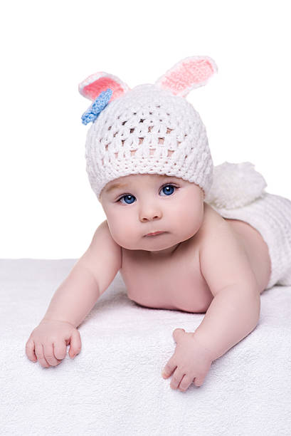 istock cute baby child in rabbit costume lying down on white 515643944