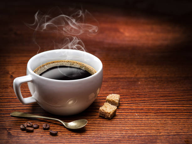 istock Cup of coffee and cane sugar cubes. 515644910