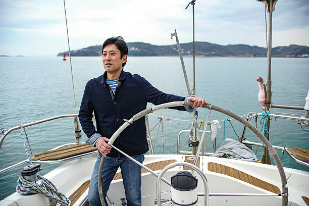istock Mature man in his 40's steering a yacht 515646284