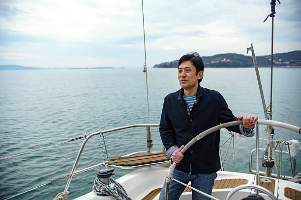 istock Mature man in his 40's steering a yacht 515646600
