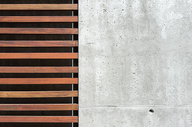 detail of the facade of a modern house exposed concrete with wooden facade elements, detail facade modern outdoor, minimalist facade reinforced concrete stock pictures, royalty-free photos & images