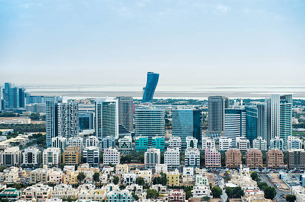 Buildings in Abu Dhabi, UAE with surrounding area viewed from the helicopter. Many details are visible in the image.