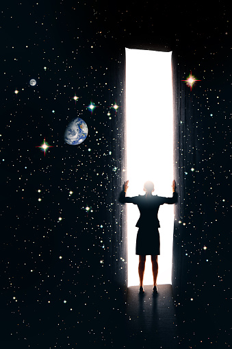 A conceptual image of a woman opening a doorway in space and time. Stars and Earth images courtesy of NASA.