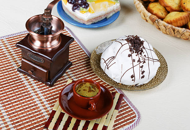 Still-life with a cup of coffee  pie and coffee grinder