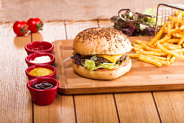 istock hamburger with fries on wooden table 515656294
