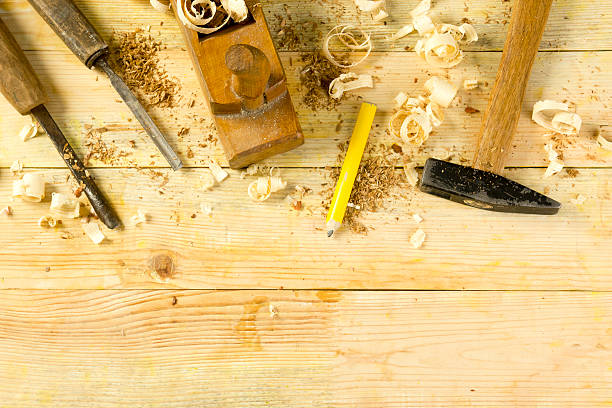 istock Carpenter tools on wooden table with sawdust. Craftperson workplace top 515656310