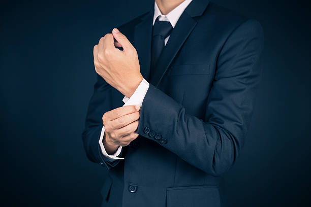 istock Businessman Fixing Cufflinks his Suit 515657782