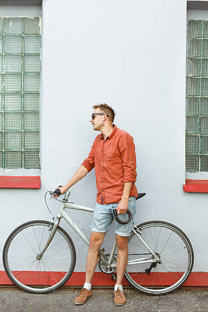 istock Cheerful man in sunglasses posing near the bicycle 515658366